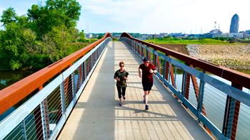 Two people are walking on a bridge.at Linc, Iowa, 50309